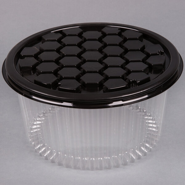 A black plastic D&W Fine Pack cake display container with a clear lid.