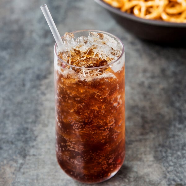 A Via Tritan plastic beverage glass filled with cola and ice with a straw.