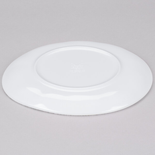 A white GET Urban Mill coupe plate with a circular design on a gray surface.