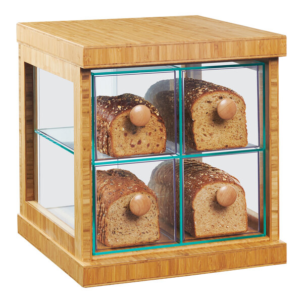 A wooden display case with four loaves of bread.