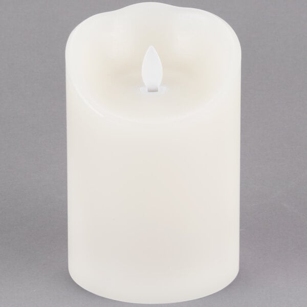 A close-up of a Sterno Mirage cream LED candle.