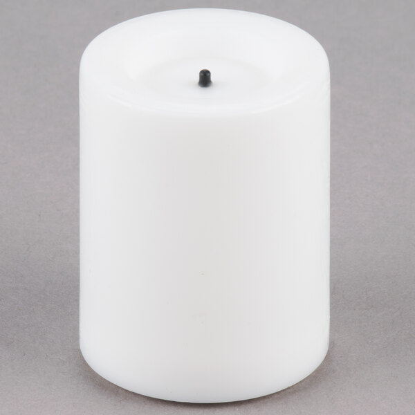 A white Sterno real wax mini votive candle with a black tip.