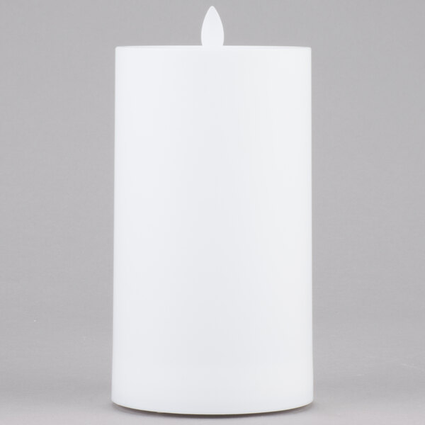 A white rectangular Sterno Mirage flameless LED candle on a gray surface.