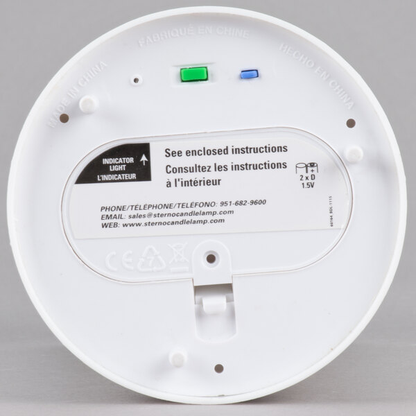 A white circular object with a green button and black and green text.