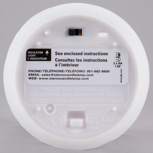 A white Sterno flameless wax pillar candle with a black Reserved decal.