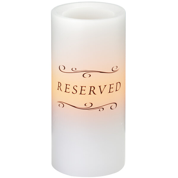 A white Sterno programmable flameless wax pillar candle with the word "reserved" on it.