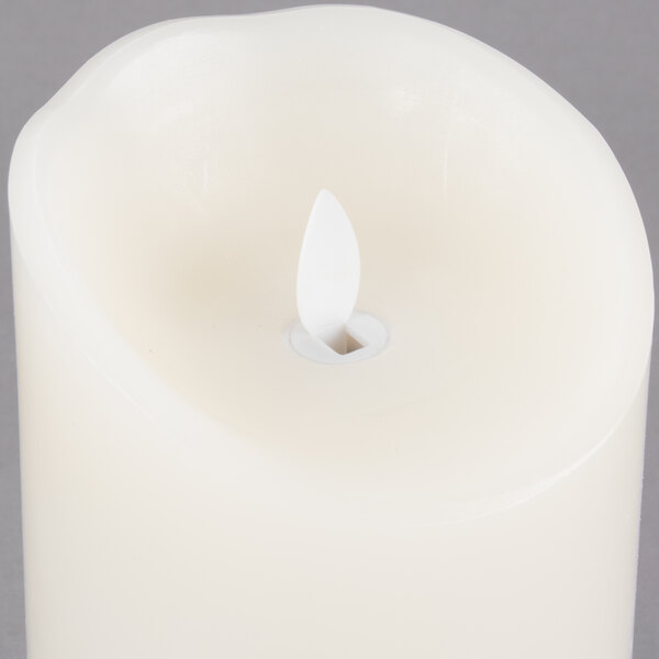 A Sterno Mirage cream flameless LED candle with a small flame.