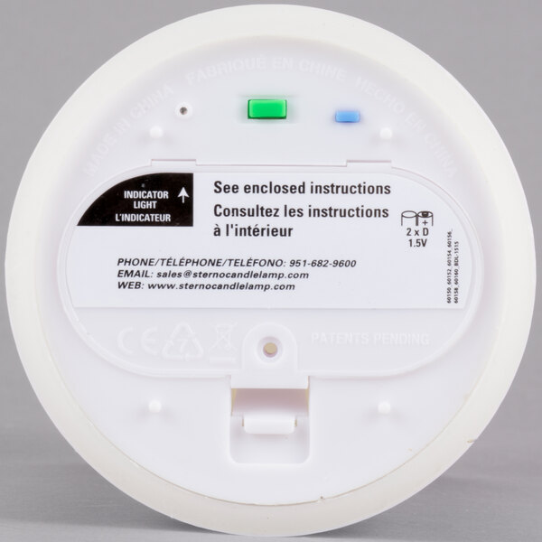 A white circular object with green and blue lights.