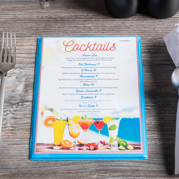 A Menu Solutions Sky Blue menu on a table with drinks.