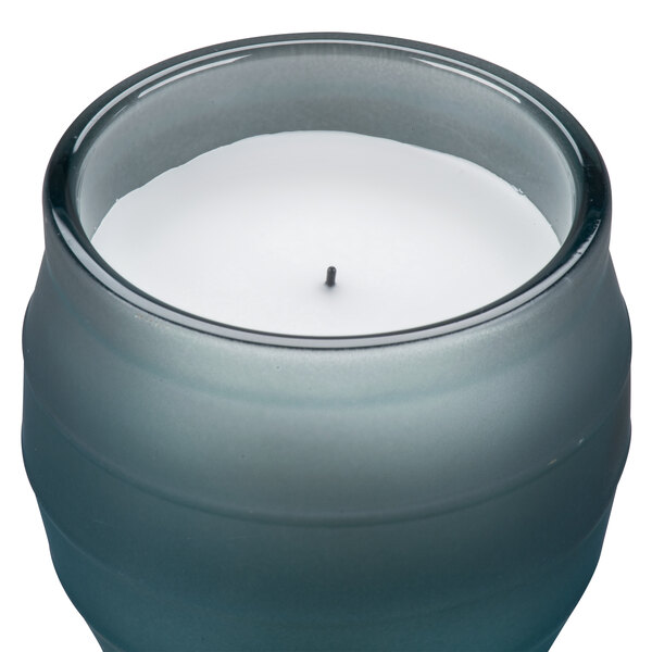 A Sterno Origin blue flameless wax filled glass candle lamp.