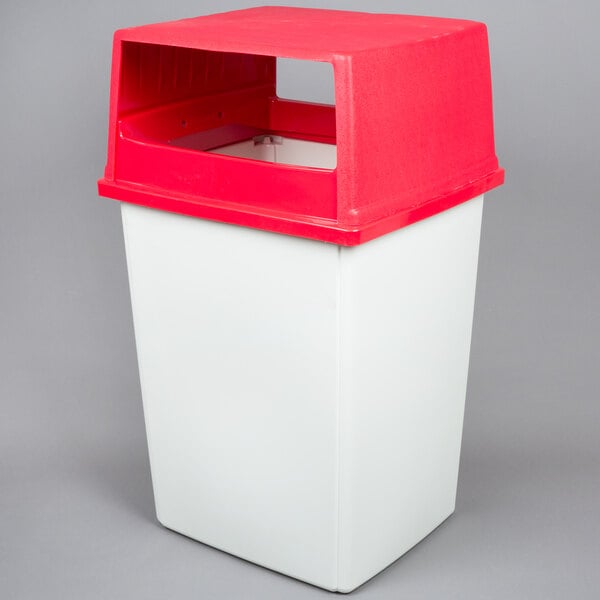 A white Rubbermaid rectangular trash can with a red lid.