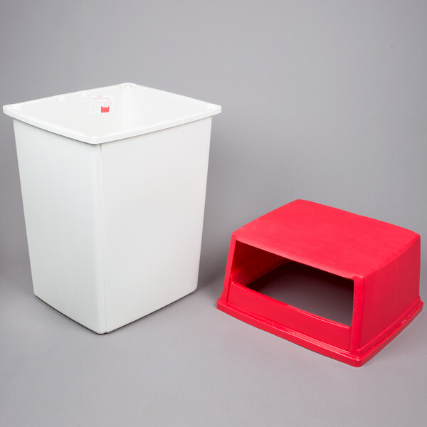 A white rectangular Rubbermaid trash can with a red lid.