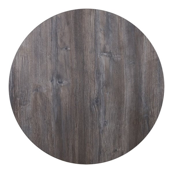 A BFM Seating round wood tabletop with a dark gray finish.