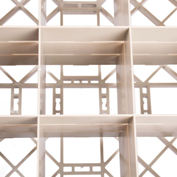 A white Vollrath Traex glass rack with white plastic shelves and holes.