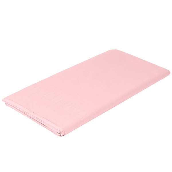A folded pink Creative Converting table cover on a white background.