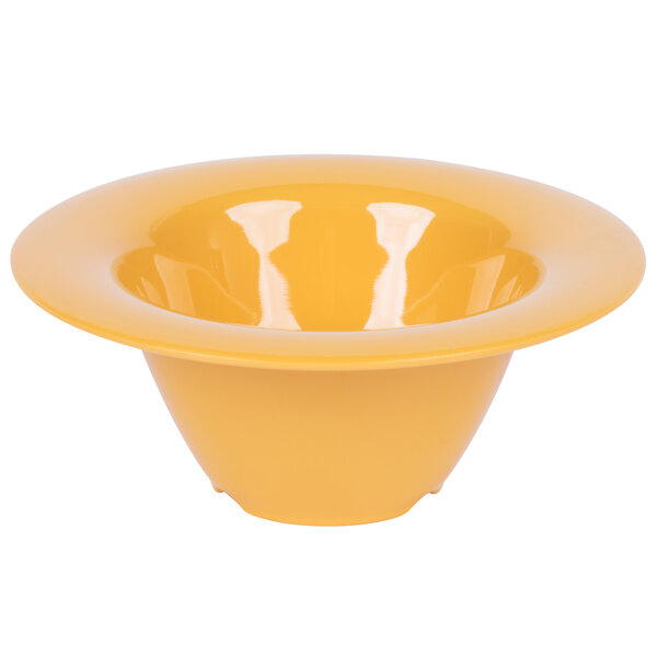 A close up of a yellow bowl with a white background.