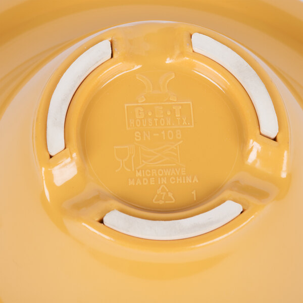 A yellow melamine bowl with a wide white rim.