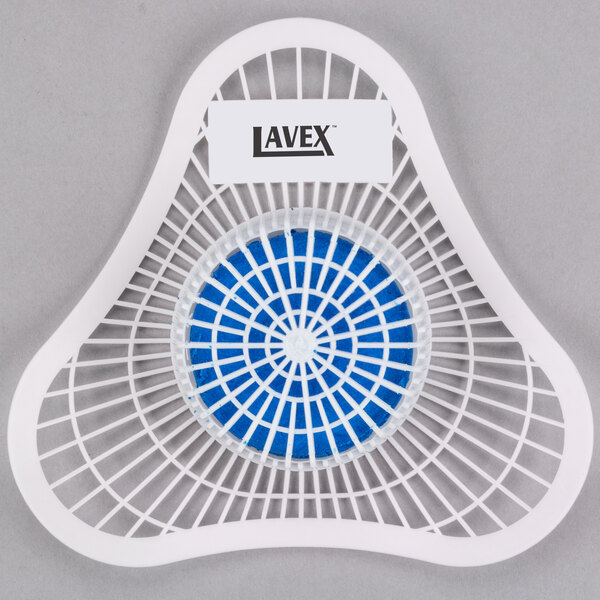 A white plastic Lavex urinal screen with blue and white circles in a mesh basket.