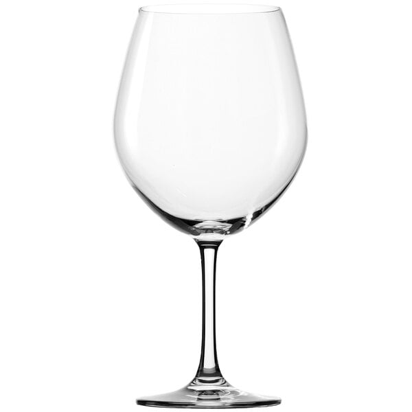 A close-up of a clear Stolzle Burgundy wine glass with a stem.