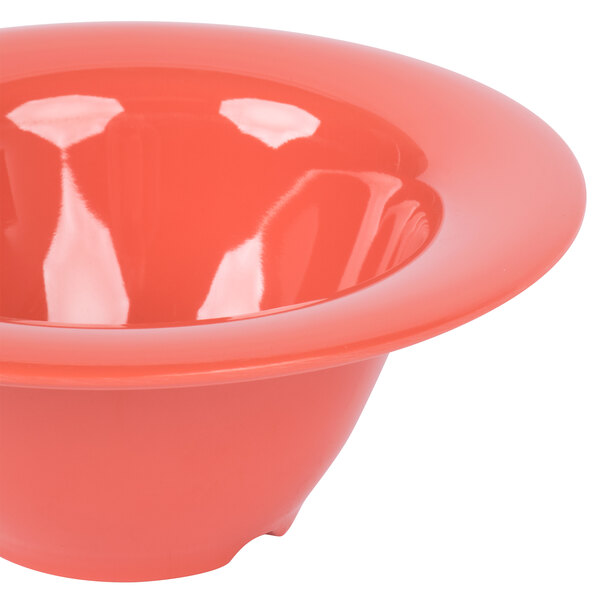 A close-up of a red melamine bowl with a wide rim.