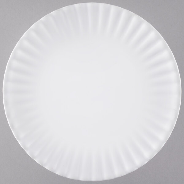 An American Metalcraft white melamine plate with a wavy edge.