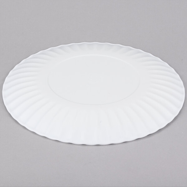 A white American Metalcraft melamine plate with a rippled edge on a gray surface.