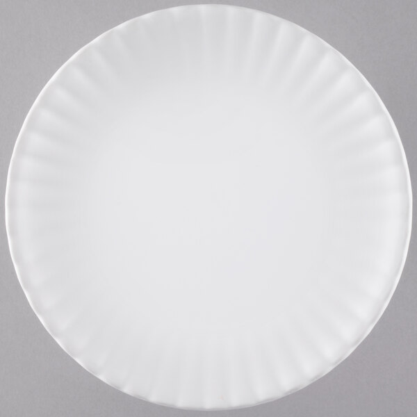 An American Metalcraft white melamine plate with a curved edge.