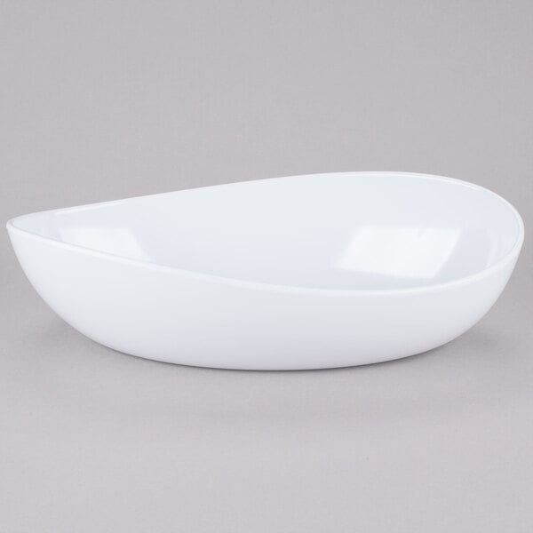 A white oval bowl on a gray surface.
