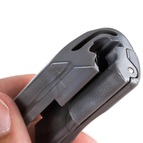 a close-up of a hand holding a grey clip