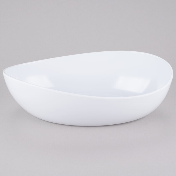 A white Osslo melamine bowl with a curved edge on a gray surface.