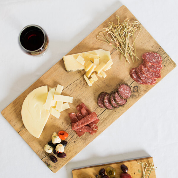 A GET faux oak wood melamine display tray with different types of food on it.