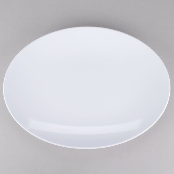 A white Osslo oval melamine platter with a white rim on a gray surface.