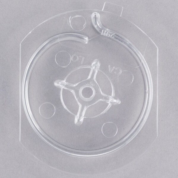 A clear plastic container with a metal rod.