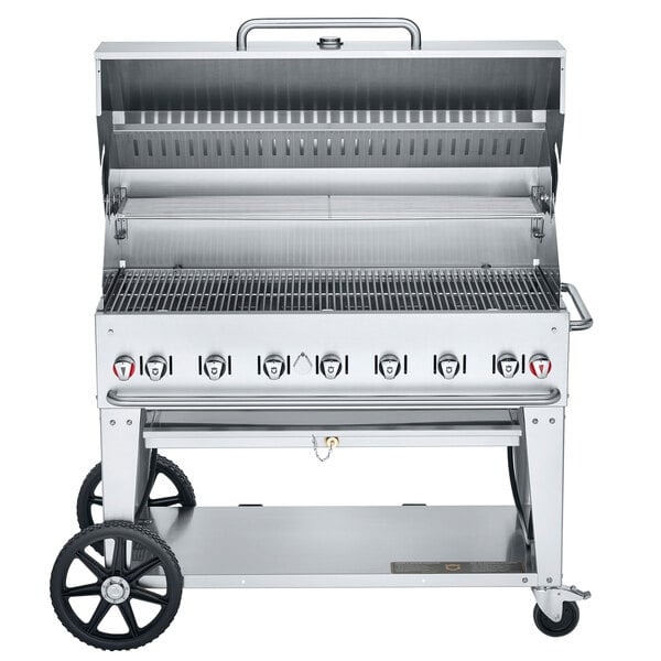 A Crown Verity liquid propane outdoor BBQ grill with wheels and an open lid.