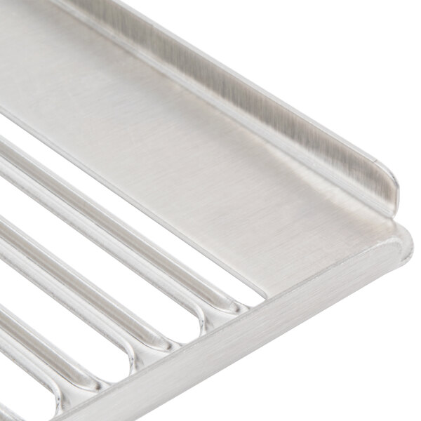 A close-up of a stainless steel metal grid for a Grindmaster Cecilware refrigerated beverage dispenser.