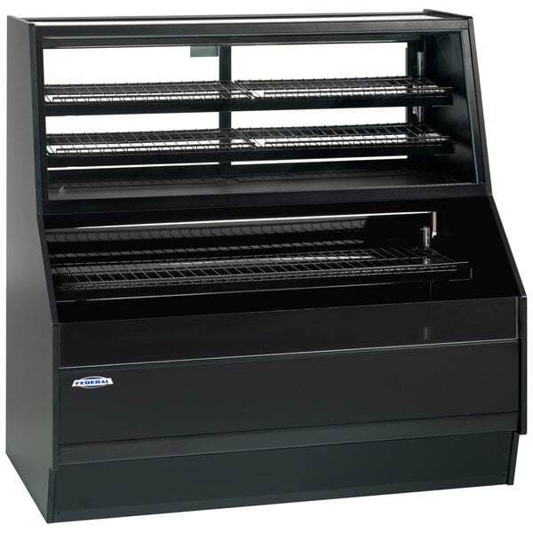 A black Federal Industries air curtain merchandiser with shelves on a counter.