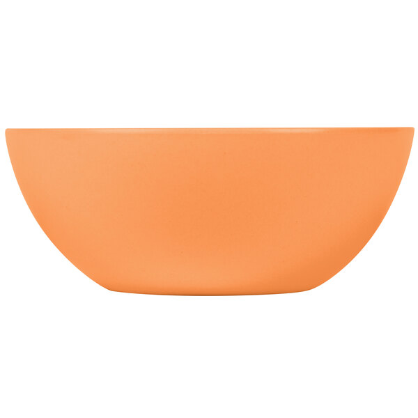 A close-up of a round bamboo salad bowl with an orange inside.