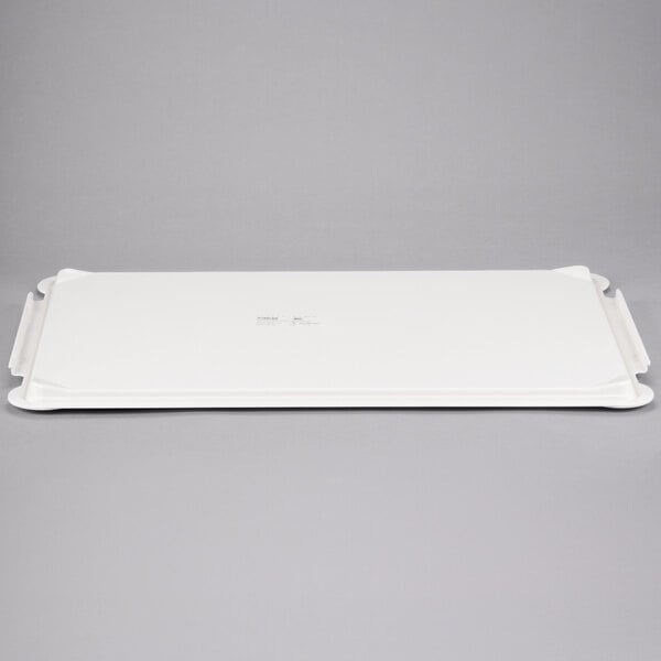 A white rectangular MFG Tray lid with handles.