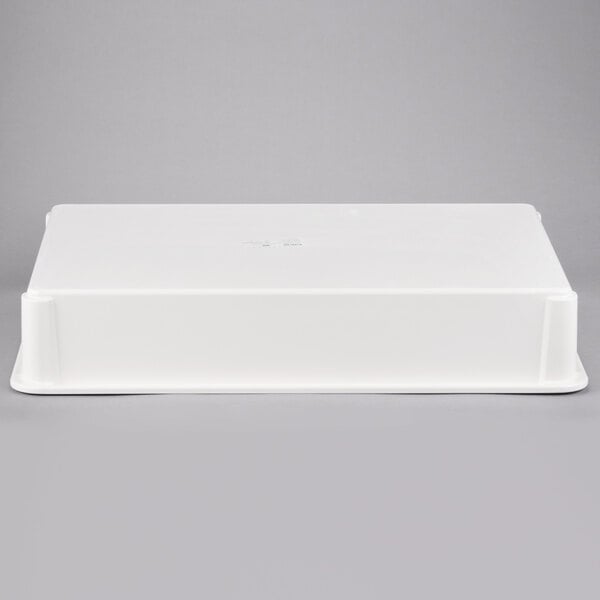 A white rectangular MFG Tray fiberglass dough proofing box on a gray surface.