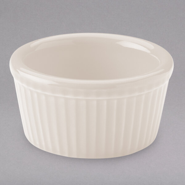 A Hall China ivory fluted ramekin with a ribbed rim.