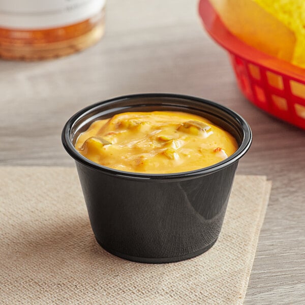 A bowl of yellow sauce on a table.