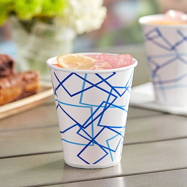 A Choice white paper cold cup with a pink drink and a lemon slice in it.