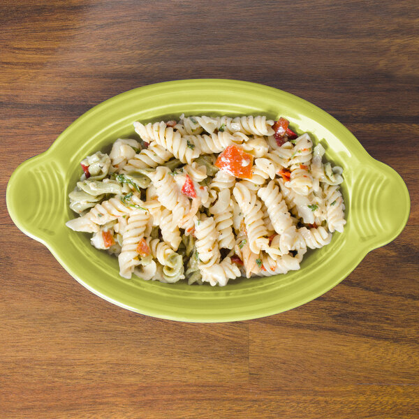 a plate of pasta on a wood table