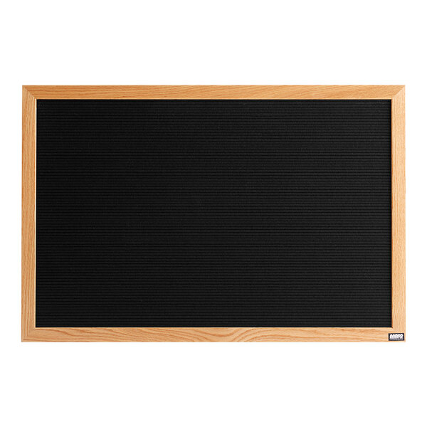 A black felt message board with a wood frame.