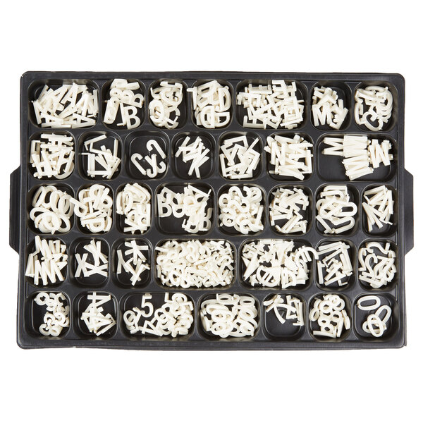 A tray of white plastic letters.