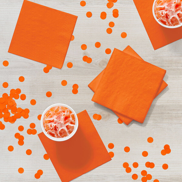 A table with cups of ice and Sunkissed Orange beverage napkins.