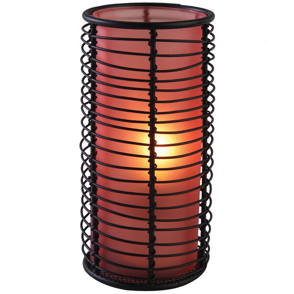 An orange frost Sterno brandy lamp with a candle holder and light.