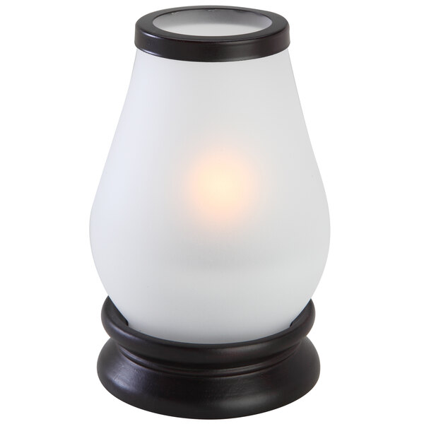 A white and brown glass candle holder with a Sterno Frost Lantern inside.