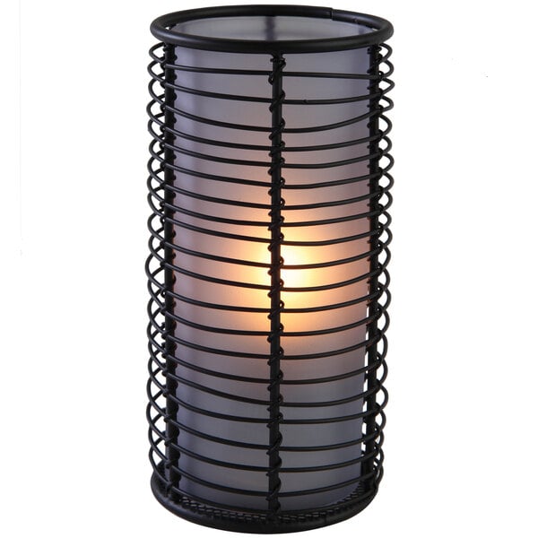 A blue frost Brandy candle lamp with a lit candle inside.