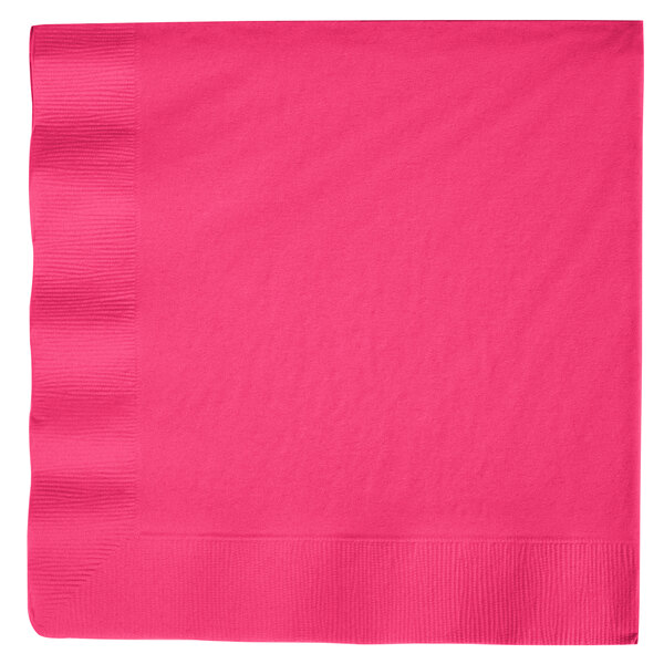 A hot magenta pink paper dinner napkin with a white background.